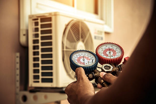 Professional Air Conditioning Service technician working in Wenham, MA